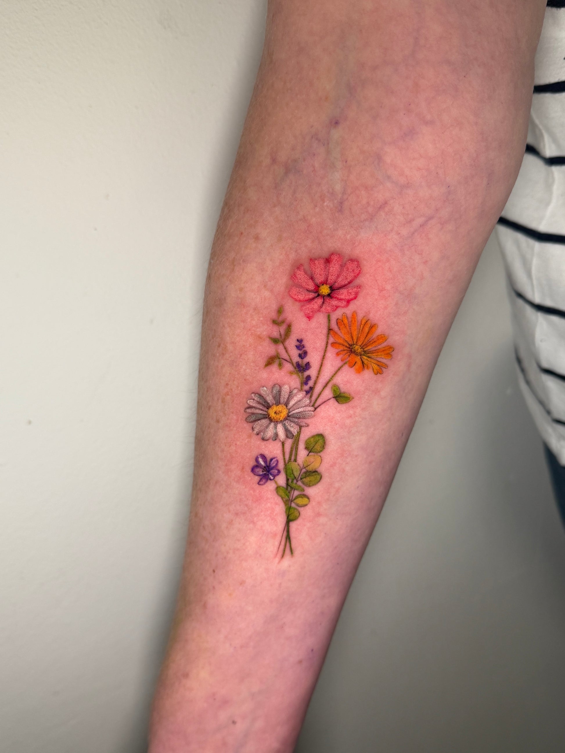 Colorful floral tattoo on arm